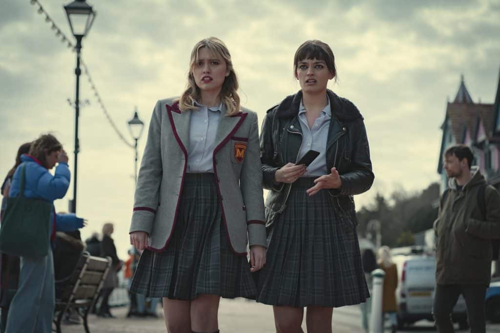  Aimee Lou Wood as Aimee Gibbs, Emma Mackey as Maeve Wiley in Episode 7 of Sex Education Season 3. Cr. Sam Taylor/NETFLIX © 2020